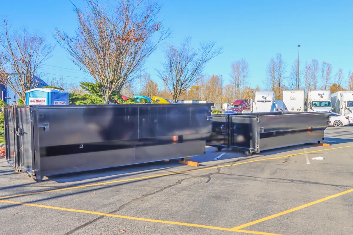 Professional dumpster rental service with roll-off container on residential driveway in Polk City